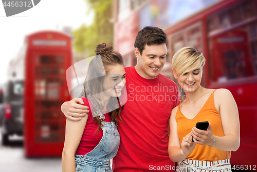 Image of friends with smartphone over london city street