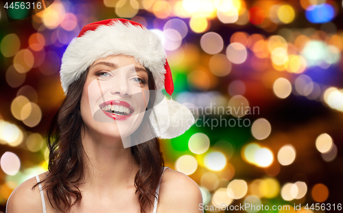 Image of woman with red lipstick in santa hat at christmas