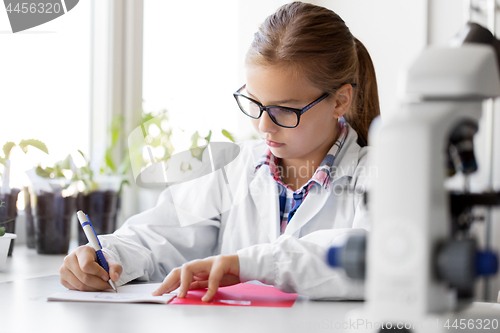 Image of girl studying chemistry at school laboratory