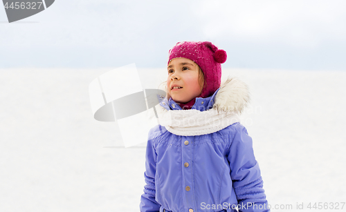 Image of happy little girl in winter clothes outdoors