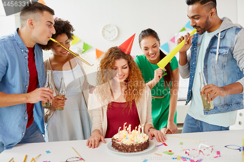Image of happy coworkers with cake at office birthday party
