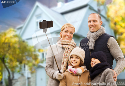 Image of family takes autumn selfie by cellphone over house