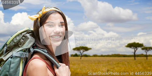 Image of happy woman with backpack over savannah