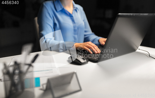 Image of close up of female hands with laptop and mouse