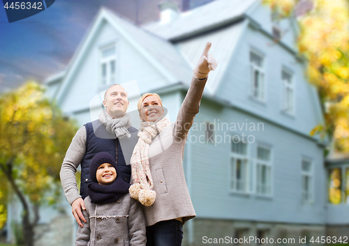 Image of happy family over living house in autumn