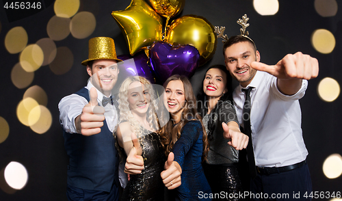 Image of friends at christmas party showing thumbs up