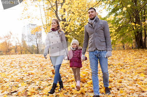 Image of happy family walking at autumn park