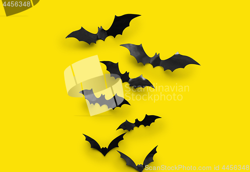 Image of black halloween bats on yellow background