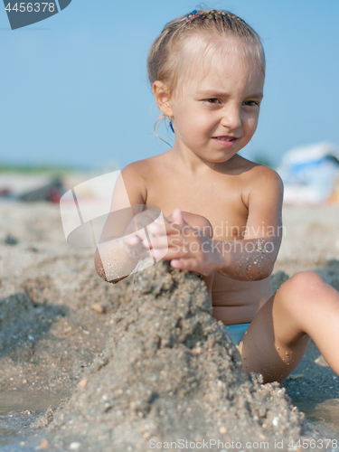 Image of Little girl on sandy beach