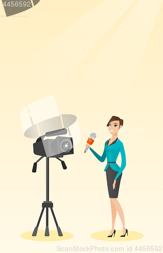 Image of TV reporter with a microphone and a camera.