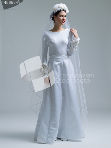 Image of young bride in a wedding dress with a veil