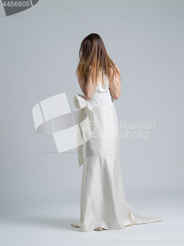 Image of Rear view of a beautiful young woman in a wedding dress