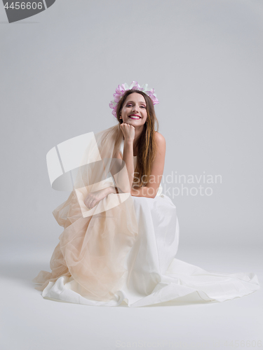 Image of young bride sitting in a wedding dress