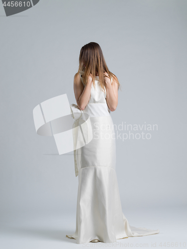 Image of Rear view of a beautiful young woman in a wedding dress