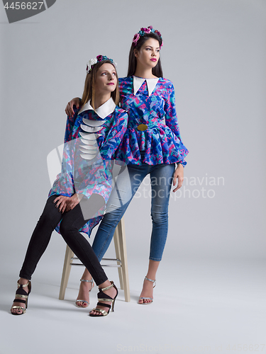 Image of two Fashion Model girls isolated over white background