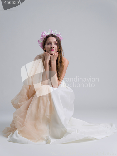 Image of young bride sitting in a wedding dress