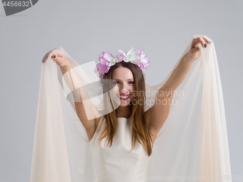 Image of young bride in a wedding dress with a veil