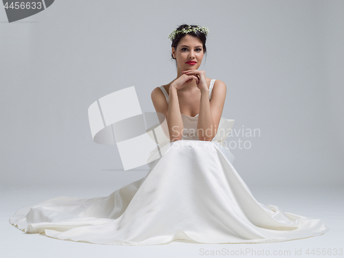 Image of young bride sitting in a wedding dress