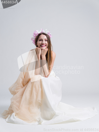 Image of young bride sitting in a wedding dress