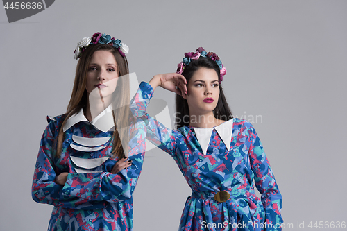 Image of two Fashion Model girls isolated over white background