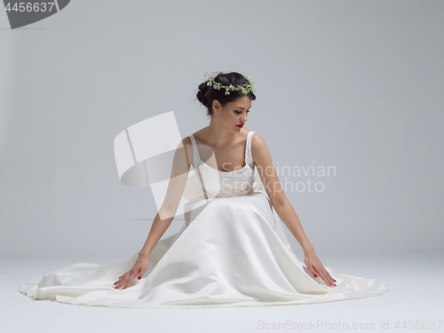 Image of young bride sitting in a wedding dress