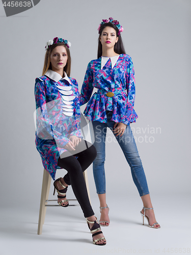 Image of two Fashion Model girls isolated over white background