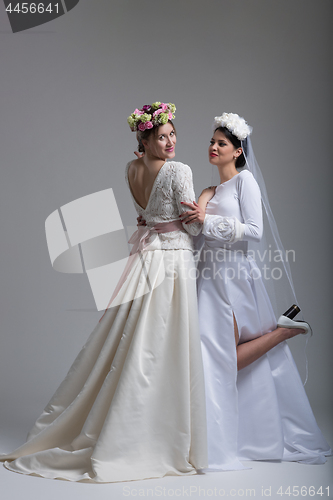 Image of Portrait of two beautiful young bride in wedding dresses