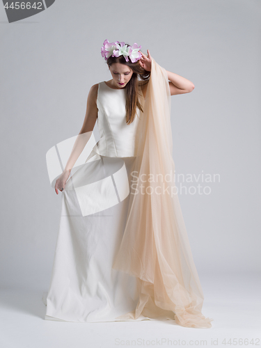 Image of young bride in a wedding dress with a veil