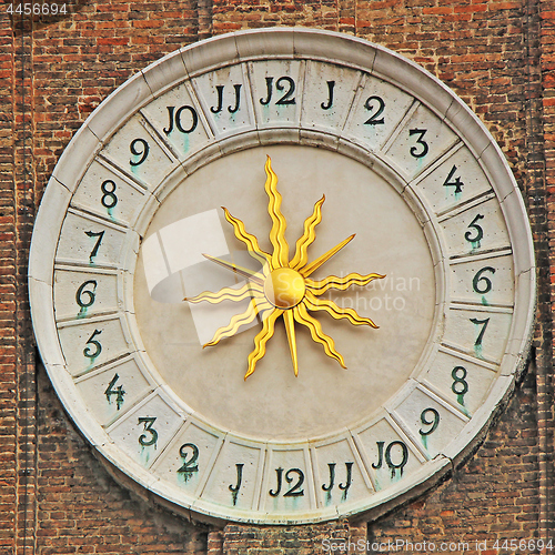 Image of Clock With Golden Sun on bell tower in Campo Santi Apostoli in V