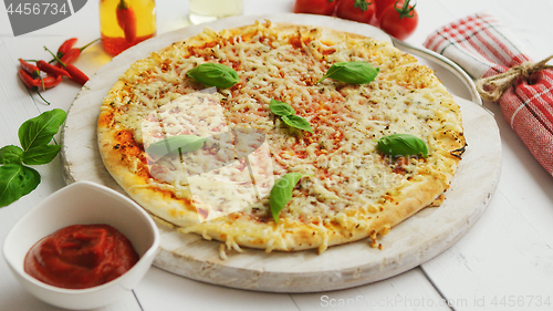 Image of Delicious italian pizza served on wooden table, shot from side