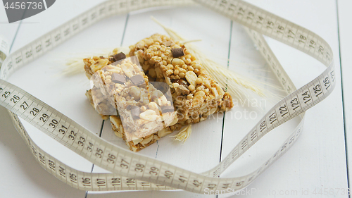 Image of Granola bars with dried fruits wooden background