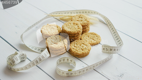 Image of Healthy oatmeal cookies on white wood background, side view.