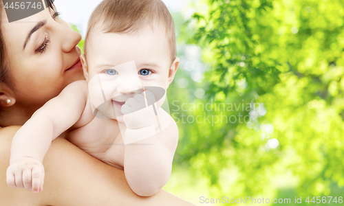 Image of mother with baby over green natural background