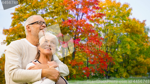 Image of senior couple over autumn park background