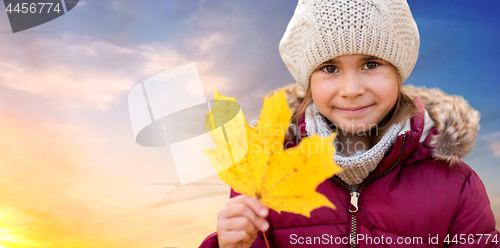 Image of close up of girl with maple leaf in autumn