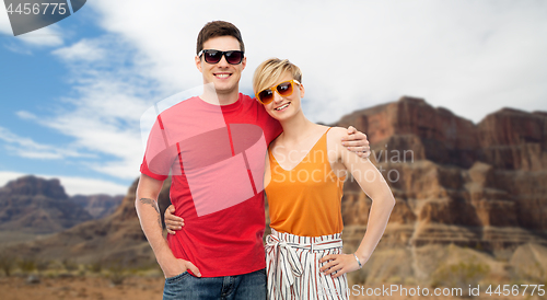 Image of couple in sunglasses hugging