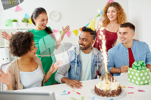 Image of office team greeting colleague at birthday party