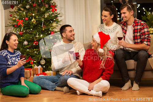 Image of friends celebrating christmas and drinking wine