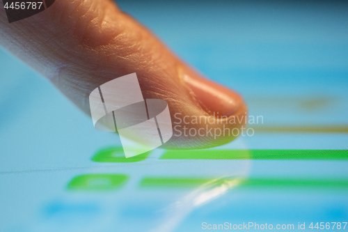 Image of close up of hand using computer touch screen