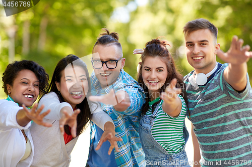 Image of happy smiling friends having fun in park
