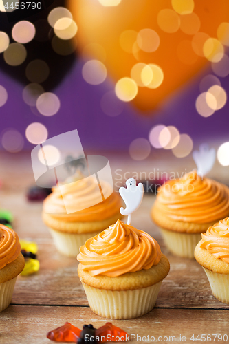 Image of cupcakes with halloween decoration on table