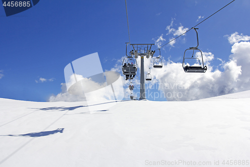 Image of Mountain slopes with Ski lift on a winter sunny day