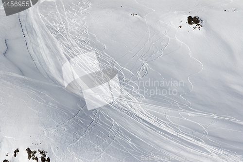 Image of Snow off-piste slope with traces of skis and snowboards