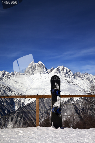 Image of Snowboards in outdoor cafe at ski resort at sun winter day