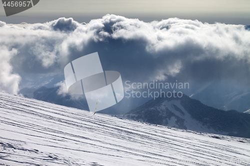 Image of Ski slope for slalom and sunlight storm clouds