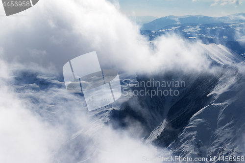 Image of Winter snow mountains in sunlight clouds