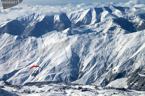 Image of Paragliding at snow mountains over ski resort