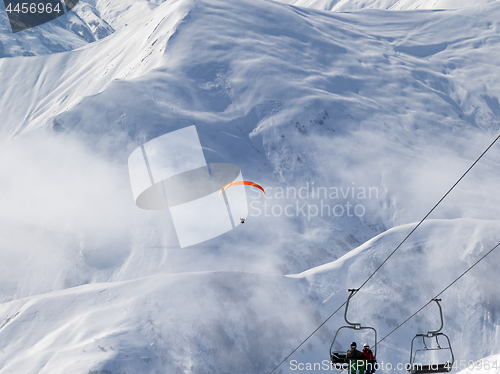 Image of Chair-lift and paraplane on ski resort at cold winter day