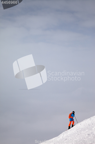 Image of Skier before downhill on freeride slope and overcast misty sky