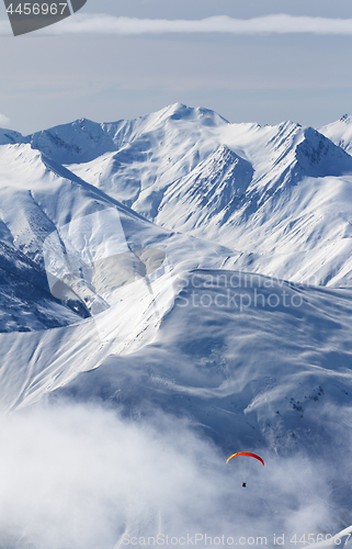 Image of Paragliding at snow mountains in haze
